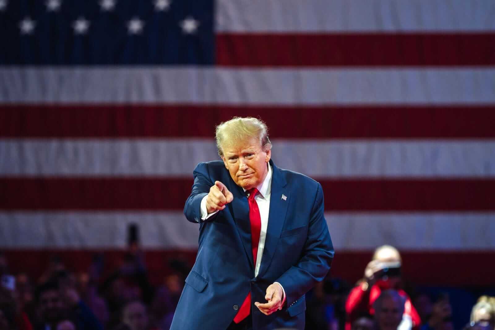An image of Donald Trump pointing to the crowd in front of an American flag background_ Image by Jonah Elkowitz via  Shutterstock_